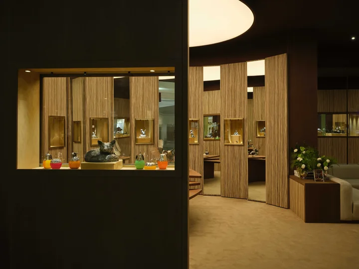 Warm wood surfaces and display cases at the Buccellati pavilion at Downtown Design Dubai 2025