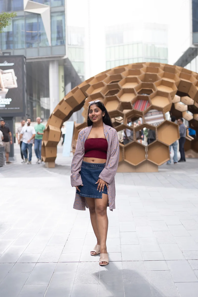 A Design Safari participant beside a honeycomb-shaped pavilion at Dubai Design Week 2025