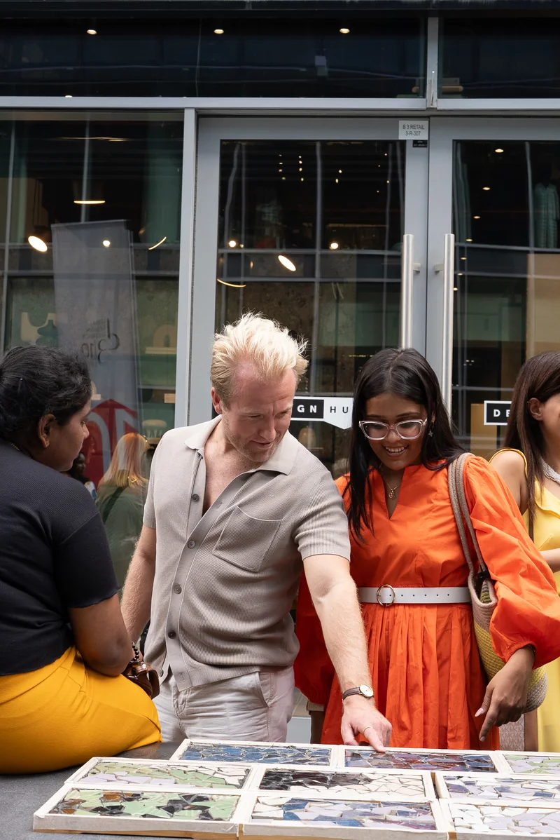 Design Safari participants looking through design references with a presenter at Dubai Design Week 2025
