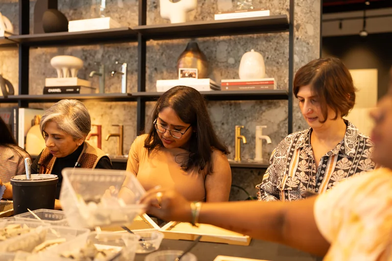 Design Safari participants working with materials together at a workshop during the 2025 visit